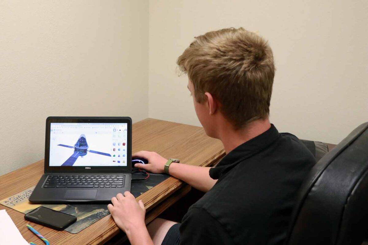 A teenager works on a project for the Orion spacecraft